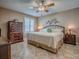 Comfortable bedroom with a ceiling fan, window with shutters, and classic furniture at 1206 Thompson Ave, The Villages, FL 32162