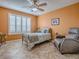 Cozy guest bedroom with a single bed, a comfortable armchair, and window at 1206 Thompson Ave, The Villages, FL 32162