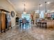 Open-concept dining area featuring tile floors and stylish furniture adjacent to the kitchen island at 1206 Thompson Ave, The Villages, FL 32162