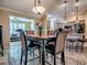 Dining area adjacent to the kitchen and living area, features elegant decor and lighting at 1206 Thompson Ave, The Villages, FL 32162