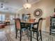 Cozy dining area with four chairs, a table with hardwood finish, and a decorative overhead light fixture at 1206 Thompson Ave, The Villages, FL 32162