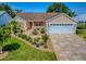 Charming single-story home featuring well-maintained landscaping and a two-car garage at 1206 Thompson Ave, The Villages, FL 32162