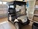Featured golf cart has custom seats, windshield, and all-weather enclosure for comfortable rides at 1206 Thompson Ave, The Villages, FL 32162