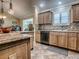 Well-equipped kitchen with granite countertops, tile backsplash, and stainless steel appliances at 1206 Thompson Ave, The Villages, FL 32162
