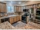 Bright kitchen featuring stainless steel appliances, granite countertops, and ample cabinet space at 1206 Thompson Ave, The Villages, FL 32162