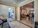 Living room view showcasing the transition to outdoor patio, dining, and kitchen areas at 1206 Thompson Ave, The Villages, FL 32162