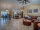 Open-concept living space flowing into the kitchen, featuring a leather sectional at 1206 Thompson Ave, The Villages, FL 32162