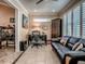 Well-lit home office with a black leather sofa, decorative accents, and an organized workspace at 1206 Thompson Ave, The Villages, FL 32162