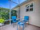 Enclosed patio featuring comfortable outdoor seating with beautiful backyard views at 1206 Thompson Ave, The Villages, FL 32162