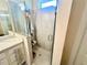 Modern bathroom with a tiled shower and sleek fixtures at 12077 Lakeshore Way, Oxford, FL 34484