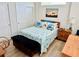 Cozy bedroom with light wood floors, closet, and serene decor at 12077 Lakeshore Way, Oxford, FL 34484