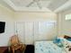 Bedroom with ceiling fan, recessed lighting, and closet with mirrored doors at 12077 Lakeshore Way, Oxford, FL 34484