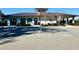 Community clubhouse with well-maintained landscaping and ample parking at 12077 Lakeshore Way, Oxford, FL 34484