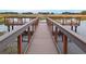 Waterfront deck with comfortable seating in a tranquil setting at 12077 Lakeshore Way, Oxford, FL 34484