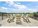 Scenic outdoor community space with Adirondack chairs overlooking a pond at 12077 Lakeshore Way, Oxford, FL 34484