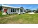 Charming home with well-manicured lawn and covered front porch at 12077 Lakeshore Way, Oxford, FL 34484