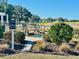 Community fire pit area with seating and scenic water views offering a relaxing outdoor experience at 12077 Lakeshore Way, Oxford, FL 34484