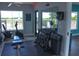 Community fitness center with weights, cardio equipment, and natural light at 12077 Lakeshore Way, Oxford, FL 34484