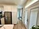 Bright kitchen featuring stainless steel appliances, white cabinetry, and wood flooring at 12077 Lakeshore Way, Oxford, FL 34484