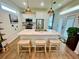 Bright open kitchen with plank floors, pendant lights, and an island with counter seating at 12077 Lakeshore Way, Oxford, FL 34484