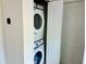 Convenient laundry room with a stacked washer and dryer set at 12077 Lakeshore Way, Oxford, FL 34484