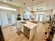 Bright, open floor plan features plank floors, natural light, and views from the island sink at 12077 Lakeshore Way, Oxford, FL 34484