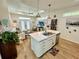 Bright, open living space with modern fixtures, plank floors, and an open kitchen layout at 12077 Lakeshore Way, Oxford, FL 34484