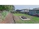Expansive backyard with a fire pit, garden space, and lush greenery, perfect for outdoor entertaining and relaxation at 1224 Lakeview Dr, Clermont, FL 34711