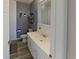 Stylish bathroom featuring a sleek white vanity, modern fixtures, and decorative wall accents at 1224 Lakeview Dr, Clermont, FL 34711