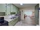 Charming kitchen with stainless appliances, granite countertops, and a view into the living area at 1224 Lakeview Dr, Clermont, FL 34711