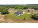 Aerial view showcasing the home's positioning on a well-manicured lot with mature trees at 12565 Cynthia Ln, Clermont, FL 34715