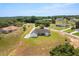 Aerial view of the property and surrounding neighborhood showcasing the home's position in a rural area at 12565 Cynthia Ln, Clermont, FL 34715