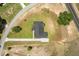 Aerial shot of the home showing its layout, driveway, and surrounding lot, situated near a road at 12565 Cynthia Ln, Clermont, FL 34715
