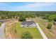 Expansive aerial view of the house showcasing its large lot, surrounding trees, and long driveway at 12565 Cynthia Ln, Clermont, FL 34715
