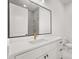 Elegant bathroom with large mirror, white vanity and gold accents at 12565 Cynthia Ln, Clermont, FL 34715