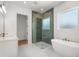 Elegant bathroom featuring a glass shower, modern tub, and luxurious finishes at 12565 Cynthia Ln, Clermont, FL 34715