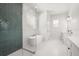 Bright bathroom with modern tub, glass shower, and dual vanity sinks at 12565 Cynthia Ln, Clermont, FL 34715