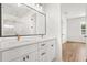 Dual sink bathroom vanity with large framed mirror and luxurious fixtures at 12565 Cynthia Ln, Clermont, FL 34715