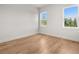 Serene bedroom with hardwood floors and windows showcasing the scenic outdoors at 12565 Cynthia Ln, Clermont, FL 34715