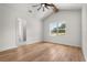 Bright bedroom with light hardwood flooring, and a large window with a view at 12565 Cynthia Ln, Clermont, FL 34715
