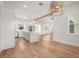 Bright, open kitchen with white cabinets, pendant lighting, and wood flooring at 12565 Cynthia Ln, Clermont, FL 34715