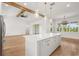 Spacious kitchen with a large island, pendant lighting, and wood floors at 12565 Cynthia Ln, Clermont, FL 34715
