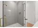 Modern shower with gray vertical subway tile, glass door, and gold hardware at 12565 Cynthia Ln, Clermont, FL 34715