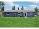 Spacious backyard featuring lush green grass and a modern home exterior at 1406 Hope Ct, Tavares, FL 32778