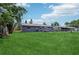 Spacious backyard featuring lush green grass and a modern home exterior at 1406 Hope Ct, Tavares, FL 32778