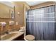 A functional bathroom featuring a sink, toilet and shower with a simple shower curtain at 1406 Hope Ct, Tavares, FL 32778