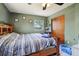 A bedroom with green walls, a ceiling fan, and one window with natural light at 1406 Hope Ct, Tavares, FL 32778