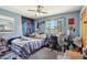 Comfortable bedroom with ample natural light, featuring a desk, bed, and blue decor at 1406 Hope Ct, Tavares, FL 32778