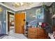 Bedroom showcasing painted walls, wooden dresser and doorway, and overhead fan with a view at 1406 Hope Ct, Tavares, FL 32778