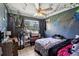 Bedroom with a ceiling fan and window, with black and white colored walls at 1406 Hope Ct, Tavares, FL 32778